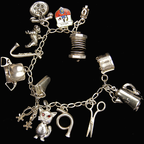 Sterling Charm Bracelet with Accordion, Cat, Scissors, Piano, Coffee Pot, Saxophone, Hunting Horn, Saddle and Stirrups and other Charms